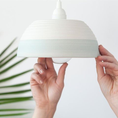 Ceramic pendant light handmade in Canada. Minimalist white and teal pendant light.